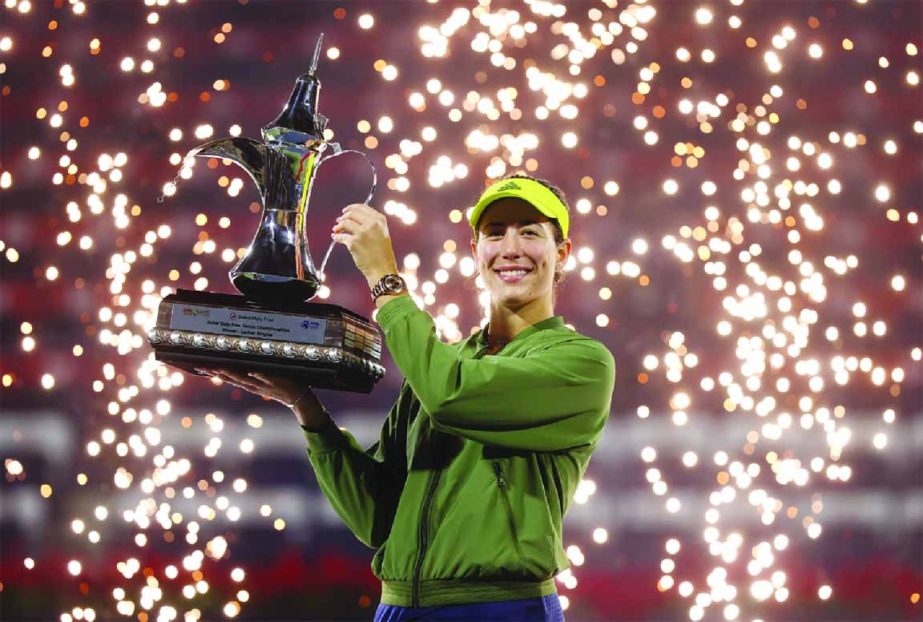 Garbine Muguruza poses with the trophy following victory during the Dubai Duty Free Tennis on Saturday.