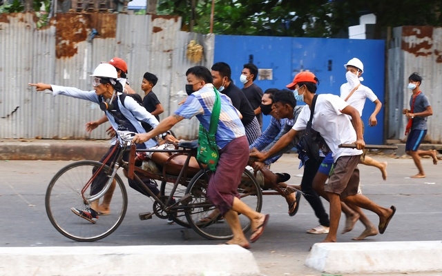 People transport a person who was shot during a security force crackdown on anti-coup protesters in Thingangyun, Yangon, Myanmar, Mar 14, 2021.