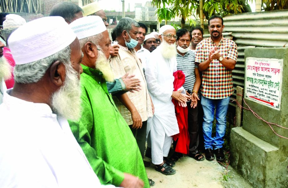 65 No. Ward Councilor of DSCC Alhaj Samsuddin Bhuiyan Sentu inaugurates a road after the name of freedom fighter Manjur Alam at Muslimnagar in the city's Matuail area on Monday.