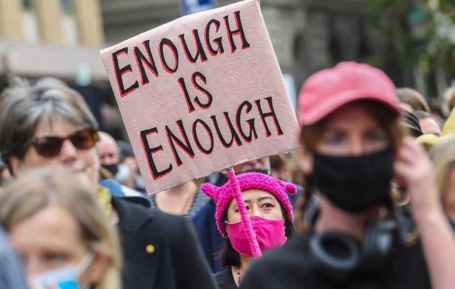A woman holds up a placard during a protest against sexual violence and gender inequality in Melbourne, Australia.