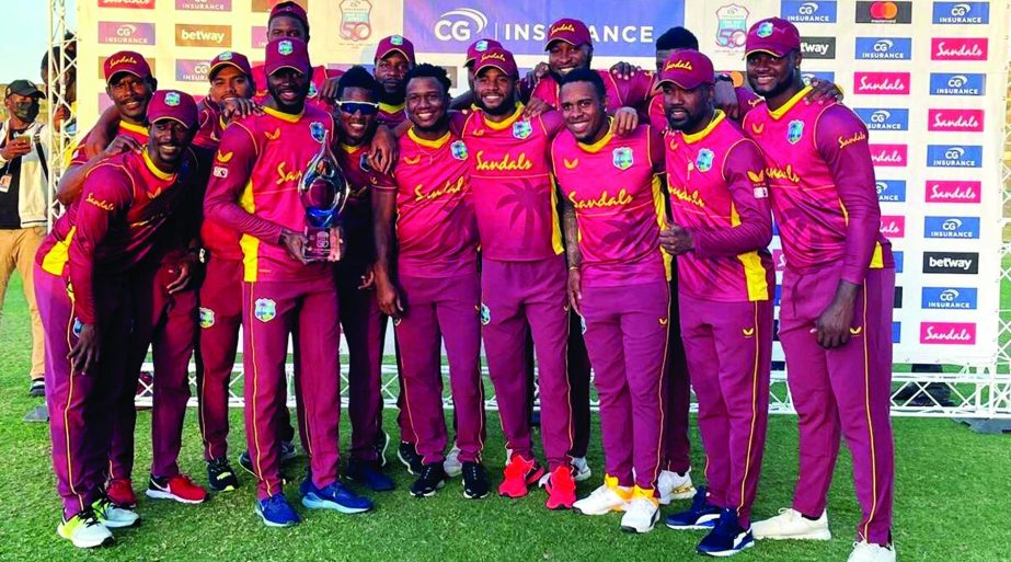 The West Indies team celebrates with the trophy after winning the 3rd and final ODI against Sri Lanka at Vivian Richards Cricket Stadium in North Sound, Antigua and Barbuda on Sunday.