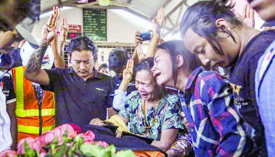 Relatives and friends react during the funeral procession in the anti-coup protests, in Mandalay, Myanmar.