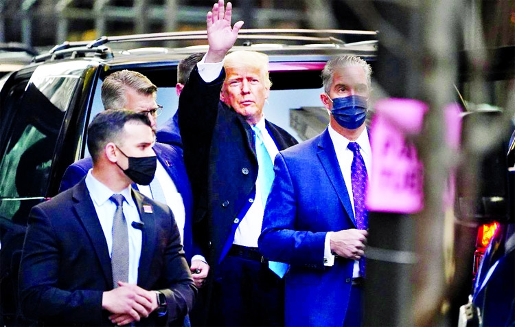 Former US President Donald Trump acknowledges people as he gets in his SUV outside Trump Tower in the Manhattan borough of New York City, New York, US.