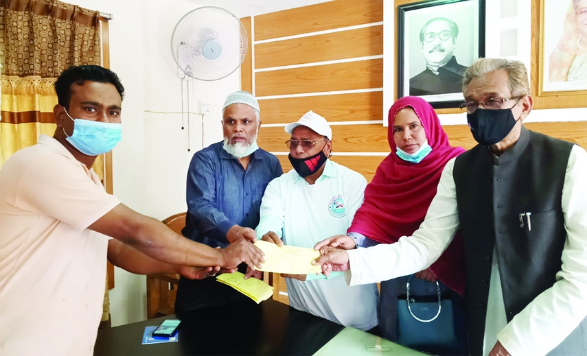 Upazilla Chairman of Gangachora Ruhul Amin distributes financial assistance among the minority ethnic community marking the birth centenary of Father of the nation Bangabandhu Sheikh Mujibur Rahman on Wednesday.