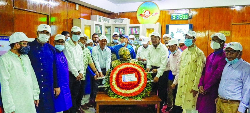 Md. Mosaddake-Ul-Alam, Managing Director of Ansar-VDP Unnayan Bank, placing floral wreath marking the birth centenary of Bangabandhu Sheikh Mujibur Rahman to his portrait at the bank's head office on Wednesday. Mohammad. Alauddin, General Manager and oth