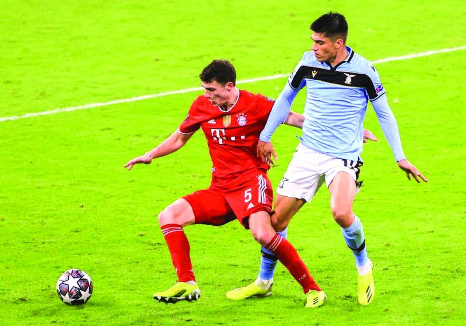 Benjamin Pavard (left) of Bayern Munich vies with Joaquin Correa of Lazio during a UEFA Champions League round of 16 second leg match between Bayern Munich and Lazio in Munich, Germany on Wednesday.