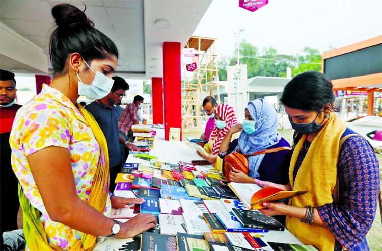 Amid sudden rise of covid-19 cases, visitors having a look at new books at Amar Ekushey Book Fair at the Suhrawardy Udyan in the city on Thursday.