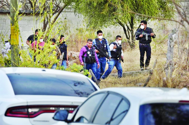 Police officers work at a crime scene where gunmen killed at least 13 Mexican police officers in an ambush, in Coatepec Harinas, Mexico.