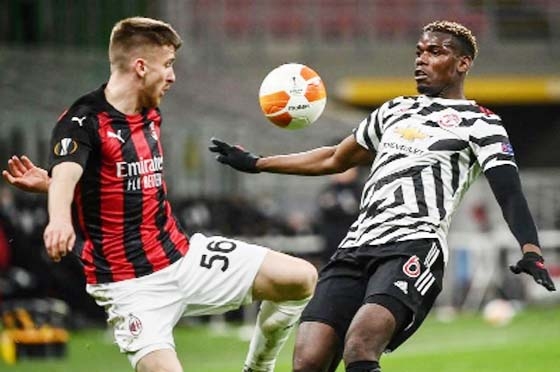 AC Milan's Belgian forward Alexis Saelemaekers (left) and Manchester United's France's midfielder Paul Pogba go for the ball during the UEFA Europa League round of 16 second leg football match between AC Milan and Manchester United at San Siro stadium