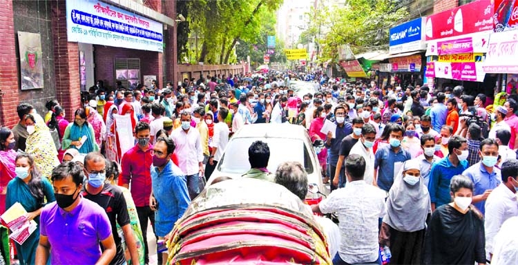 41th BCS examinees and guardians crowd out side a hall after the examination defying Covid health norms. This photo was taken in front of Lalmatia Mohila College in the capital on Friday.