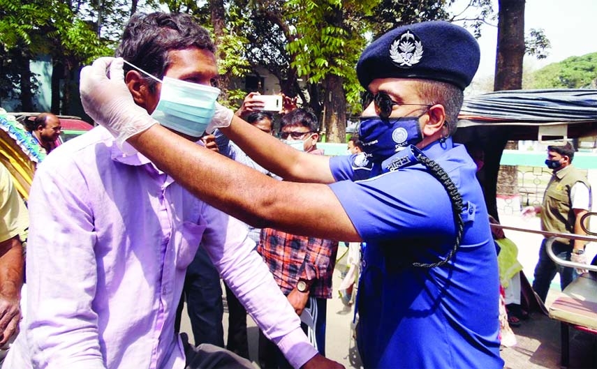 Nilphamari district police are seen affixing stickers on vehicles and distributing masks to the public in response to the second wave of corona.