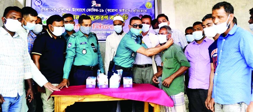 The Dakhhsin Surma Thana Police distribute masks among the local people as a part of their awareness raising program about coronavirus on Sunday.