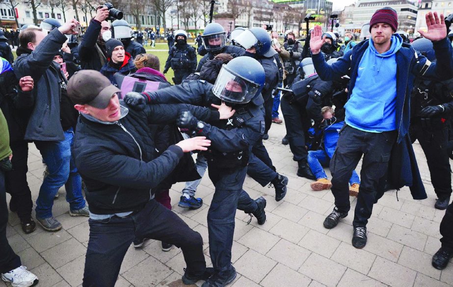 Police clear protesters from a square at the end of a demonstration demanding the compliance of basic rights and an end of the restrictive coronavirus measures in Kassel, Germany.