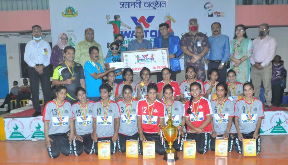 Members of Bangladesh Ansar & Village Defence Party, the champions in the women's division of the Independence Day Handball Competition with the guests and officials of Bangladesh Handball Federation pose for a photo session at the Shaheed Captain M Mans