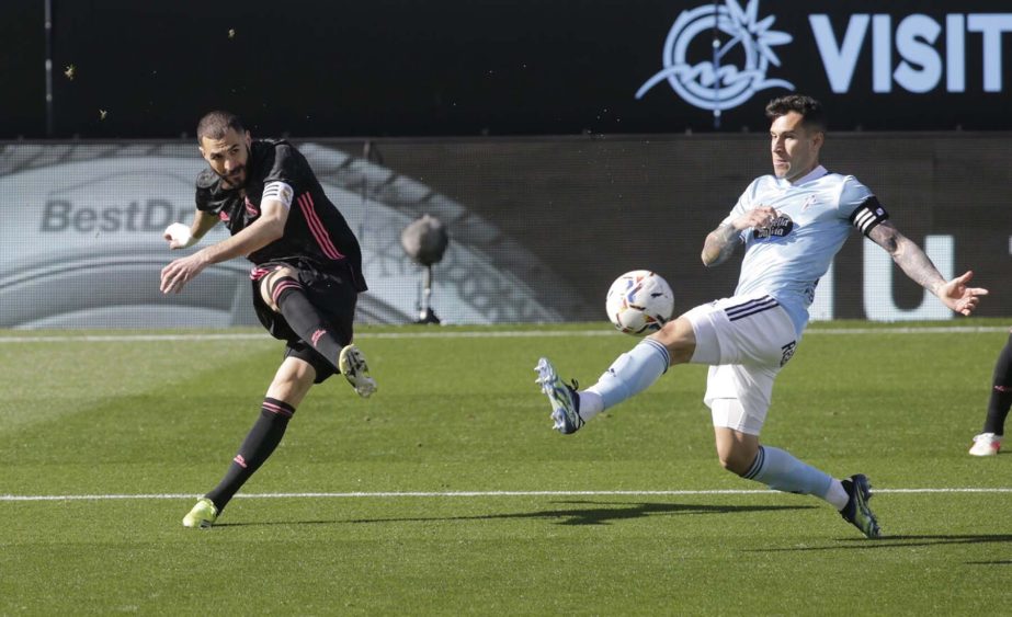 Real Madrid's Karim Benzema (left) shoots at goal to Celta Vigo goalbar during the La Liga match on Saturday.