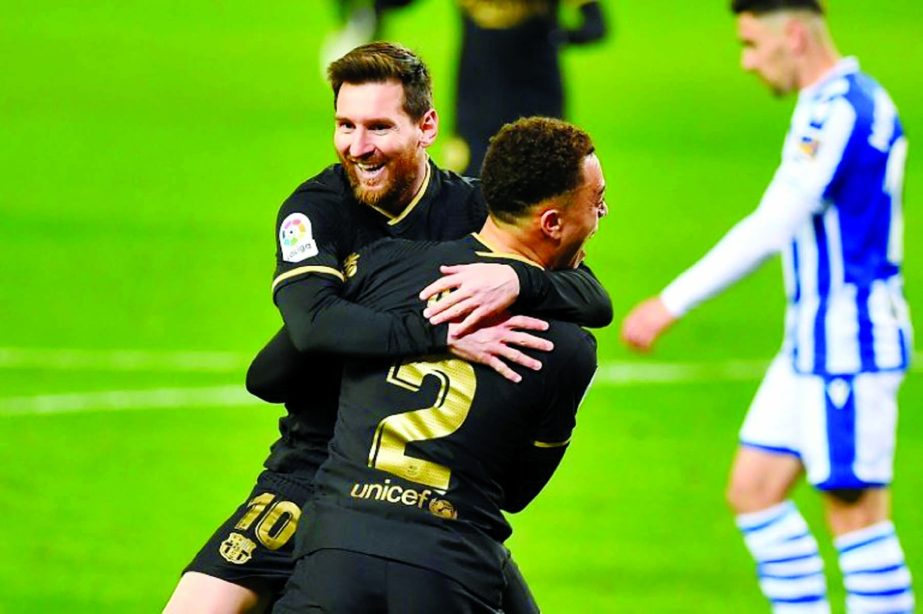 Barcelona's forward Lionel Messi celebrates with teammates after scoring a goal during their Spanish League match against Real Sociedad at the Anoeta stadium in San Sebastian on Sunday.