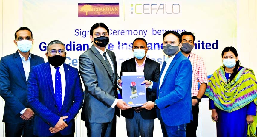 Sheikh Rakibul Karim, Acting CEO of Guardian Life Insurance Limited and Ferdous Mahmud Shaon, Managing Director of Cefalo Bangaladesh Limited, exchanging document after signing an agreement in the capital recently. Under the deal, all the employees and de