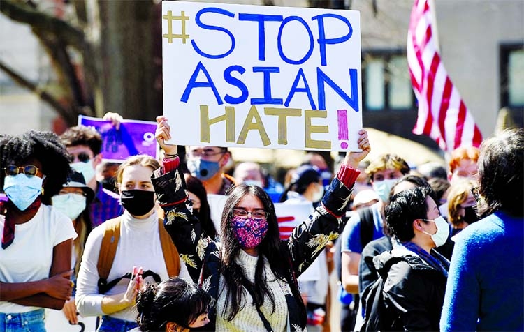 People gather at a rally to demand safety and protection of Asian communities in the aftermath of the deadly shootings in the Atlanta-area that left eight people dead in Washington.