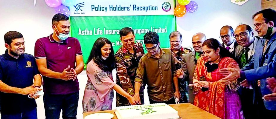 Brig Gen Md Monirul Gani, Managing Director and CEO of Astha Life Insurance Company Limited (a concern of Army Welfare Trust) along with other high officials cutting a cake at the Policy Holders' Reception at the company's head office in the capital rec