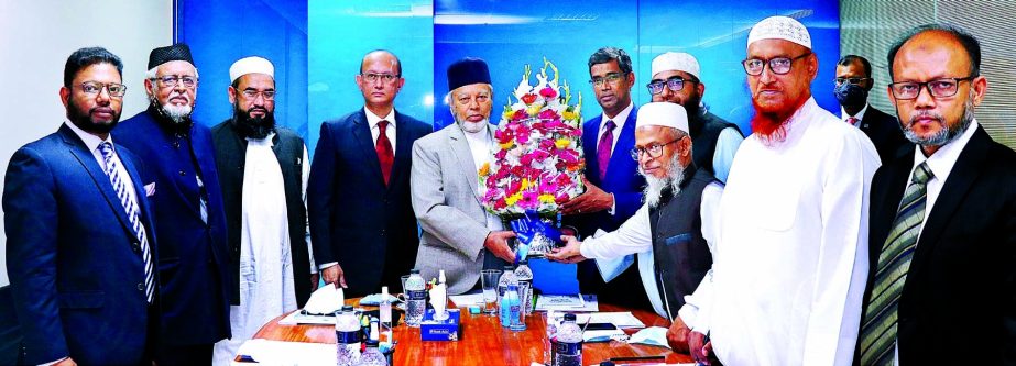 Md. Arfan Ali, President & Managing Director of Bank Asia Limited greetings with floral bouquet to Md. Farududdin Ahmad and Mawlana Shah Mohammad Waliullah, for being elected as the Chairman and Member Secretary of the Bank's Shariah Supervisory Committe
