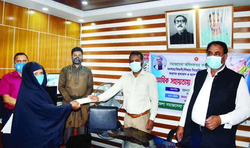 Upazilla Nirbahi Officer of Fulbaria, Mymensing Ashraful Siddique distributes cheques of financial aid among different complicated patients of the locality in a formal ceremony held at Social Service Office of the upazilla on Wednesday while Upaziil Chair