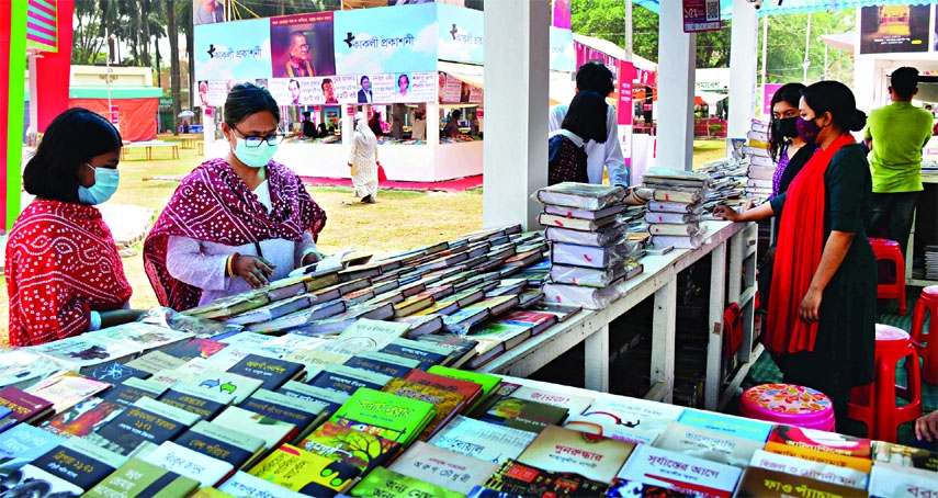 Readers visit a stall following the health norms at the Bangla Academy Book Fair at Suhrawardy Udyan in the capital on Saturday.