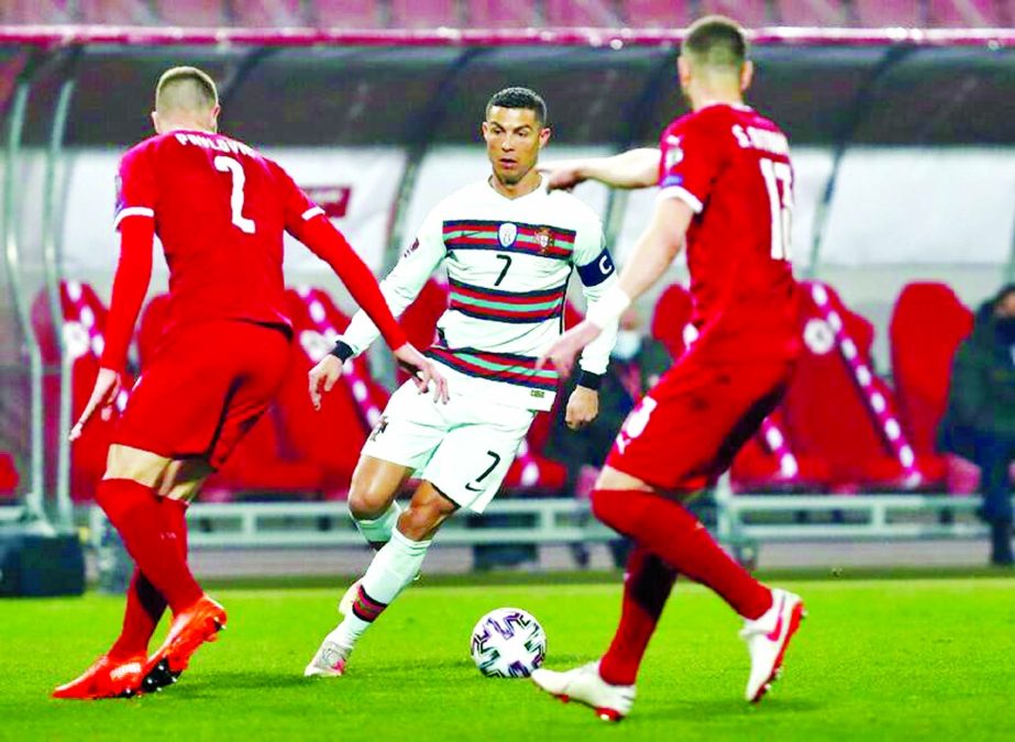 Portugal's Cristiano Ronaldo (center) in action during the World Cup 2022 group A qualifying soccer match between Serbia and Portugal at the Rajko Mitic stadium in Belgrade, Serbia on Saturday.