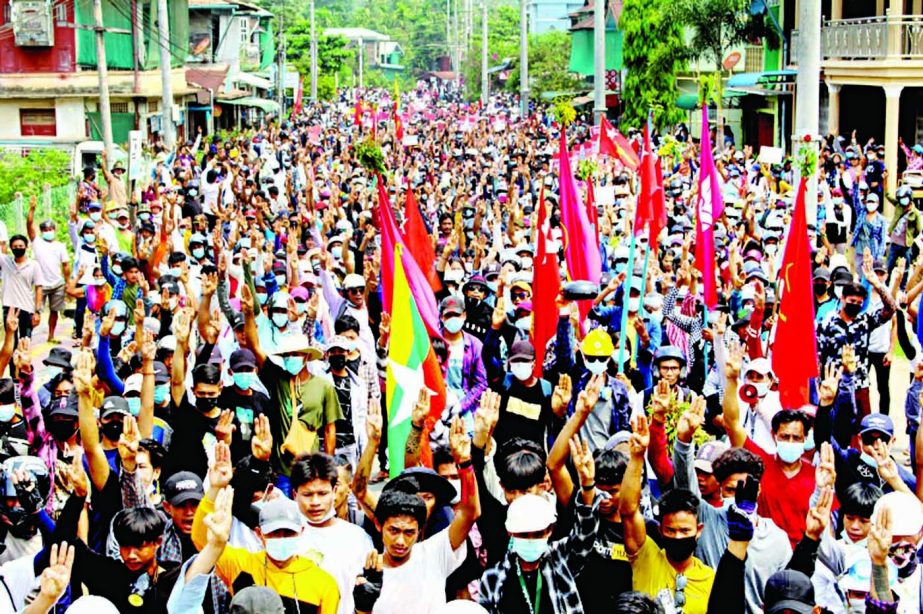 Protesters making the three-finger salute during a demonstration against the military coup in Dawei, Maynmar yesterday.