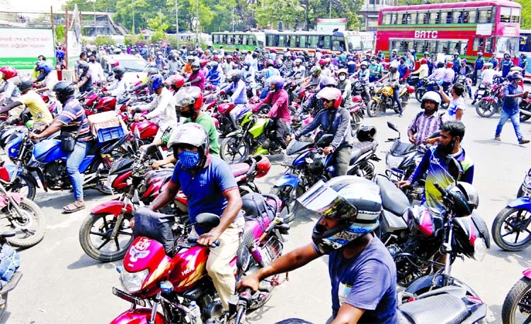 Motorcyclists bring out a procession in the city on Thursday the protesting ban on ride sharing due to Covid surge. This photo was taken from Shahbagh area.