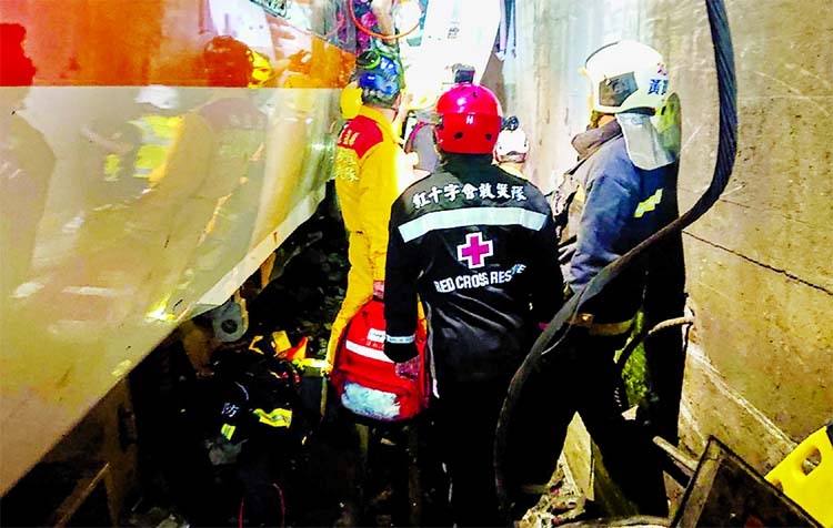 Taiwan Red Cross rescue teams at the site where a train derailed inside a tunnel in the mountains of Hualien, eastern Taiwan on Friday.