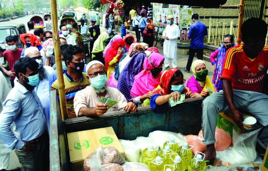 People of low-income crowd the TCB truck to buy essential commodities. The snap was taken from the city's Shahbagh area on Saturday.