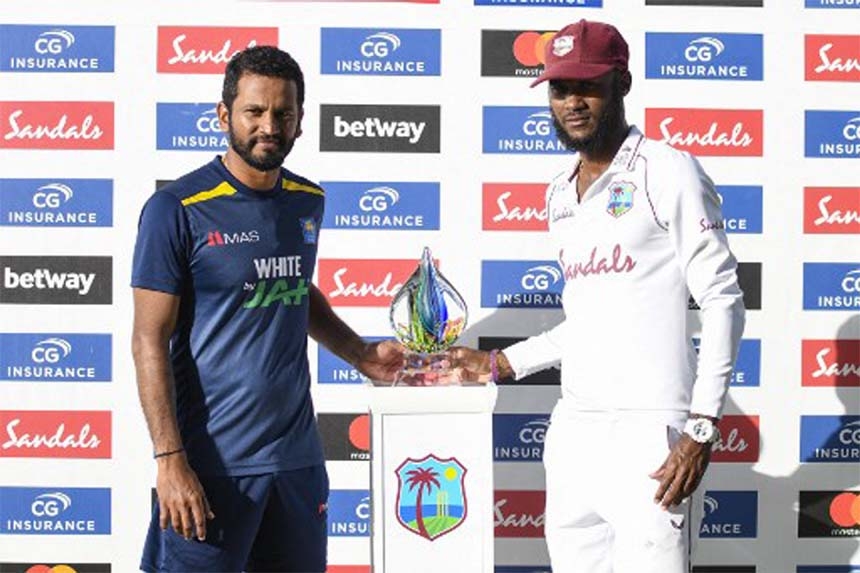 Sri Lanka captain Dimuth Karunaratne (left) and West Indies skipper Kraigg Brathwaite pose with the Test series trophy in Antigua on Friday.