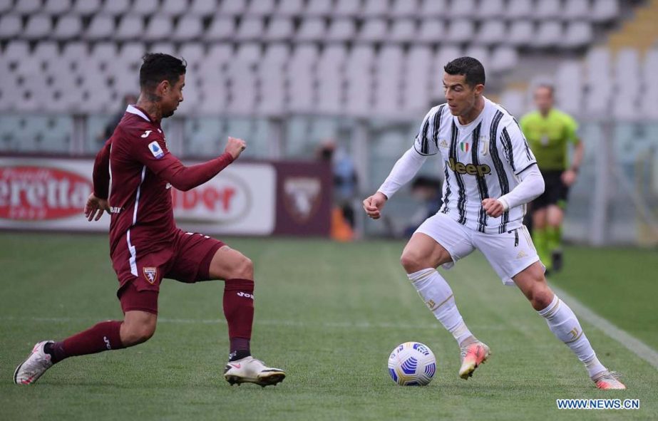 FC Juventus' Cristiano Ronaldo (right) vies with Torino's Armando Izzo during a Serie A football match between Torino and FC Juventus in Turin, Italy on Saturday.