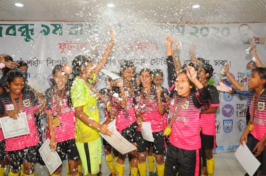 Players of Magura district team celebrate after winning gold medal in the women's football competition of the Bangabandhu 9th Bangladesh Games at the Bangabandhu National Stadium on Sunday.