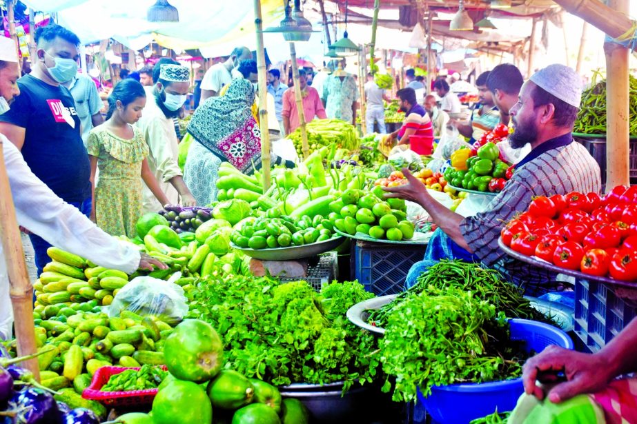 Buyers swarm in a kitchen market in the capital on Tuesday without following social distancing norms amid lockdown meant to prevent coronavirus infection.