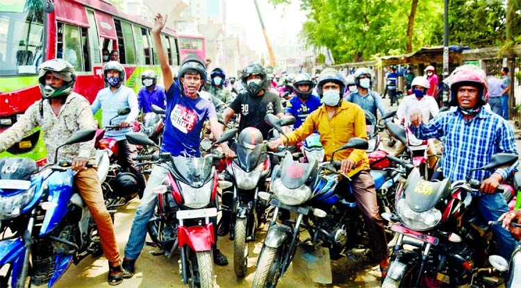Ride sharing motor cycle bikers demonstrate on Wednesday at the Jatiya Press Club in the city demanding withdrawal of ban on their services.