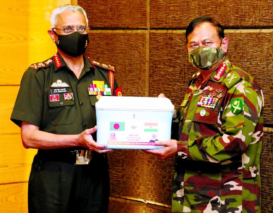 Visiting Indian Chief of Army Staff General Manoj Mukund Naravane hands over one lakh doses of Indian product corona vaccine Oxford AstraZeneca to his Bangladesh counterpart General Aziz Ahmed at the Army Headquarters in Dhaka Cantonment on Thursday.