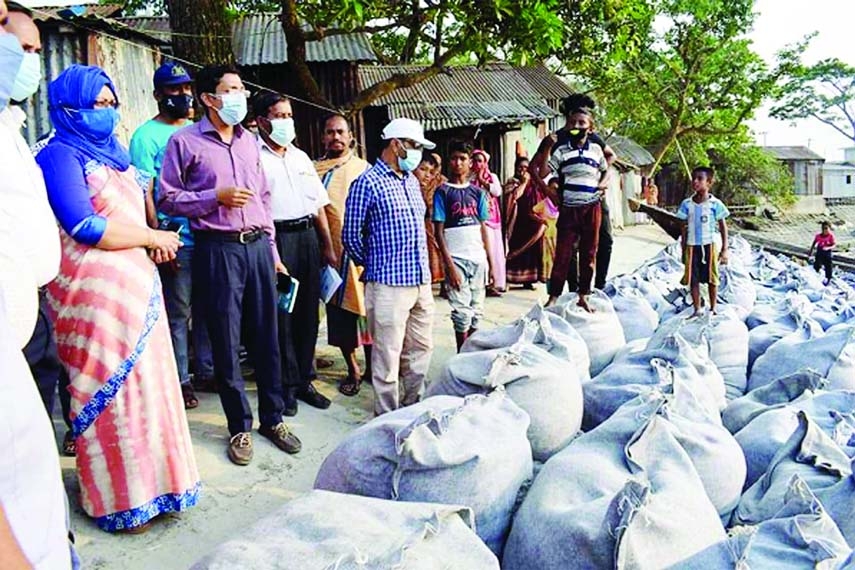 Photo shows sand filled Geo bags are being dumped in the vulnerable spot of Chandpur Town Protection Dam at Old Fire Station area at Puranbazar in Chandpur town. Locals said, a big area (about 50 metres) sank down early Monday with concrete cement