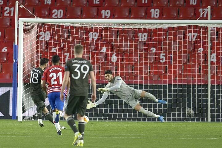 Manchester United's midfielder Bruno Fernandes (left) scores a goal during the UEFA Europa League quarter-final match against Granada FC at the Nuevo Los Carmenes Stadium on Thursday.