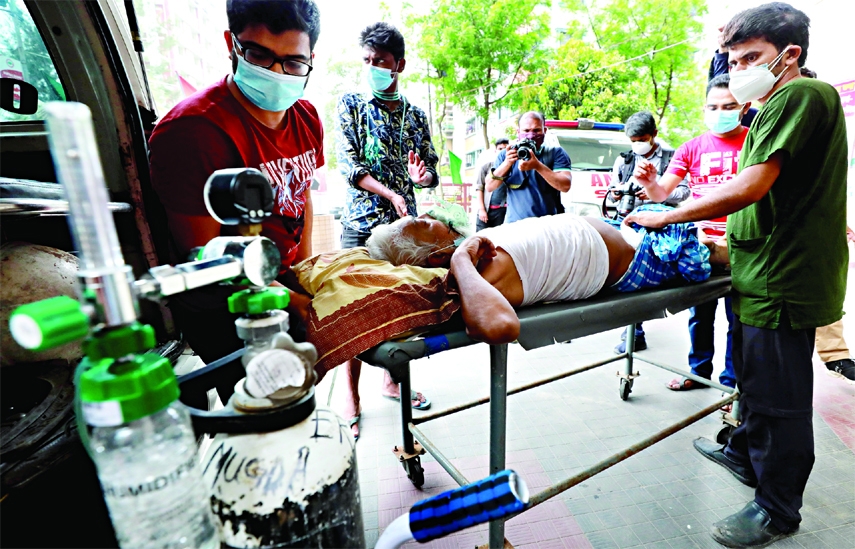 A patient having respiratory problem is being taken to Mugda Hospital in the capital on Saturday with oxygen support as Covid-19 surged rapidly across the country.