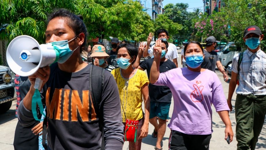 Young demonstrators flash the three-fingered symbol of resistance as they march in Yangon, Myanmar, Saturday, April 10, 2021. Security forces in Myanmar cracked down heavily again on anti-coup protesters Friday even as the military downplayed reports of s