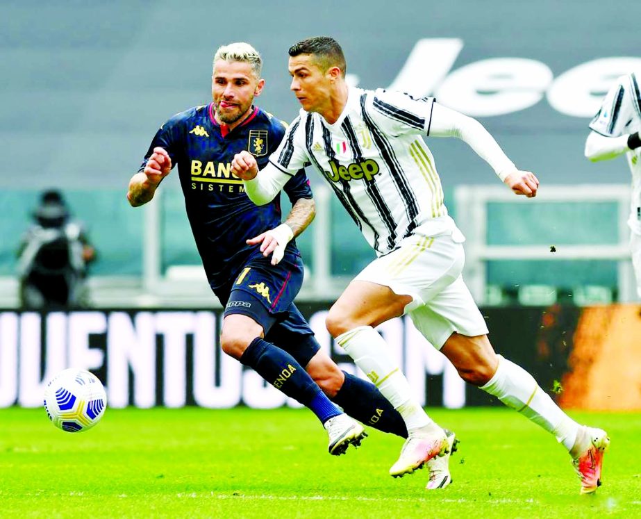 FC Juventus' Cristiano Ronaldo (right) vies with Genoa's Valon Behrami during a serie A football match between FC Juventus and Genoa in Turin, Italy on Sunday.