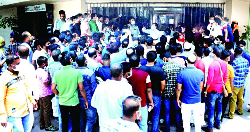 Expatriate people working in the Middle East throng the Bangladesh Biman Office at Motijheel in the capital on Monday being refused entrance to the airport despite having work permits.