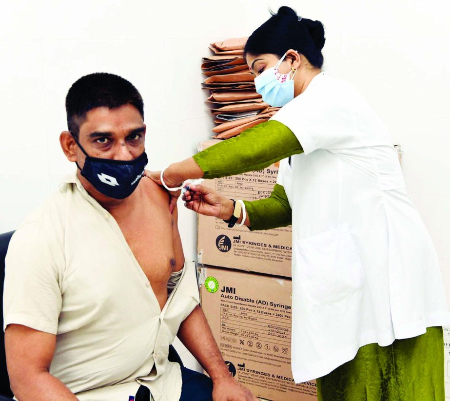 A staff of the Secretariat receives Covid-19 vaccine at Bangladesh Secretariat Clinic in the city on Thursday.