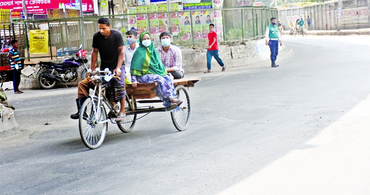 Commoners go to their respective destination riding on rickshaw-van due to absence of transports. The snap was taken from in front of Rajdhani Market on Friday.