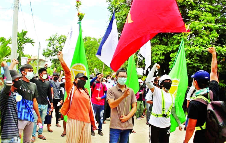 Demonstrators gesture as they protest against the military coup, in Dawei, Myanmar.