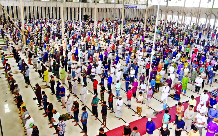 Muslim devotees attend the first Jumma prayer in the month of Holy Ramzan following the social distancing norms at Baitul Mukarram National Mosque in the city.