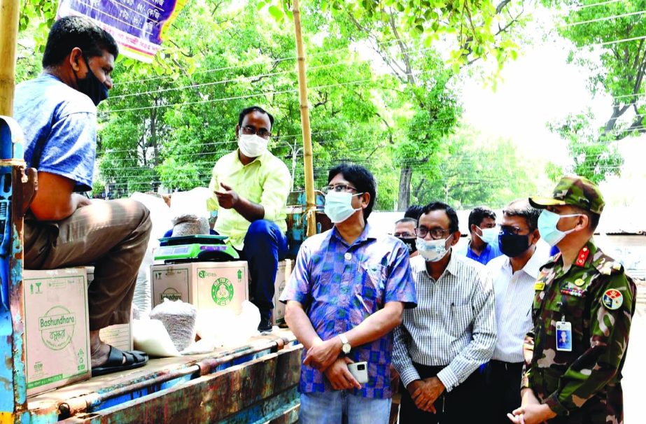 Senior Secretary of the Commerce Ministry Dr. Zafar Uddin supervises TCB commodity selling activities at New Market in the city on Saturday.