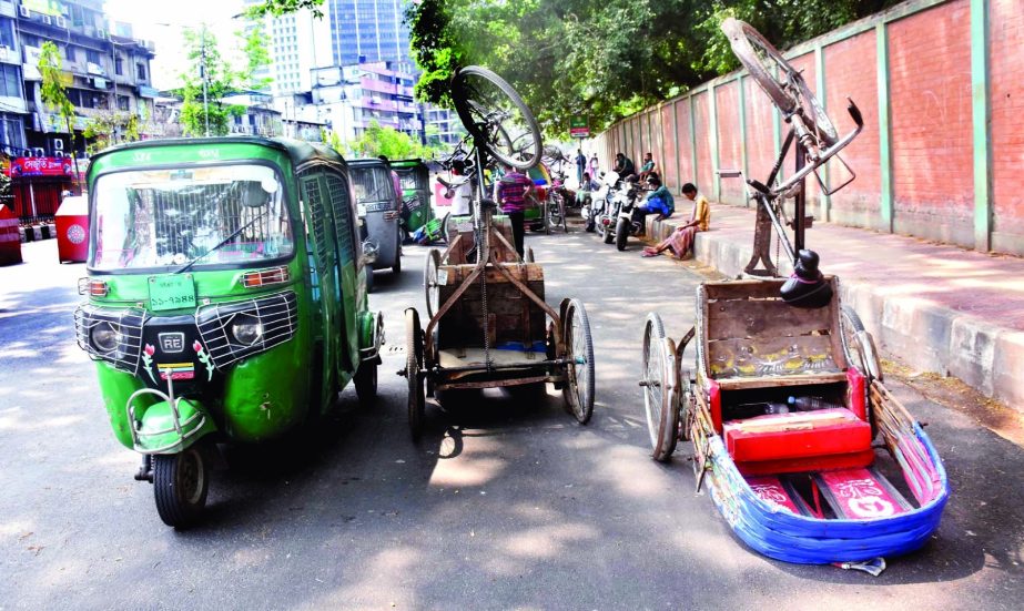 Police upturn rickshaws in front of Notre Dame College in the capital on Sunday as rickshaw pullers came out of city streets defying lockdown.