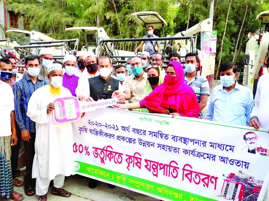 Prof Dr Md Abdul Aziz, MP of Sirajganj at a ceremony hands over keys of combine harvester machines to the farmers held at the Upazila Parishad premises on Saturday afternoon with Upazila Nirbahi Officer Mejbaul Karim in the chair.